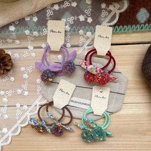 Pastel dopamine style hair ties set with colorful pompoms and floral bunny ears bows