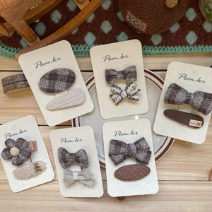 Set of girls plaid hair clips featuring bow and flower shapes in warm earth tones