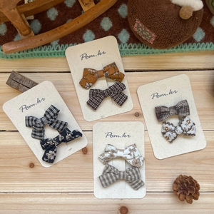 Handmade floral and plaid bow hair clips for girls set on vintage kraft card