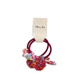 Colorful pom-pom bow elastic hair ties set for girls on a product display card
