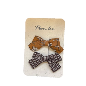 Set of two handmade bow hair clips with yellow floral print and brown plaid patterns