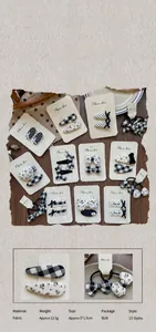 Detail shot of handmade fabric hair clip set featuring black and white polka dots and patterns