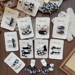 Detailed collection of handmade polka dot and plaid bow hair clips on premium cardboards