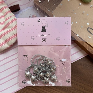 Detail of star charm elastic hair bands set in pink heart card packaging for girls