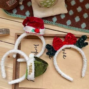 Christmas headband set with red sequin bow and Santa hat on white plush frame