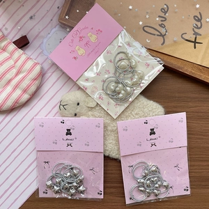 Sweet silver bow and heart pendant hair ties set for girls displayed on wooden surface