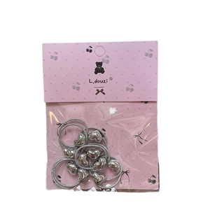 Silver elastic hair ties set with heart-shaped pendants on decorative packaging