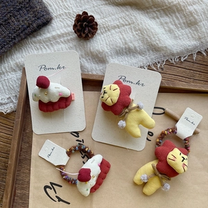 Cute lion and cake plush hair clip set on wooden tray with cozy seasonal decor
