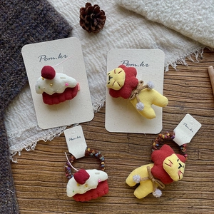 Sweet handmade plush hair clips and ties set featuring yellow lion and cupcake designs