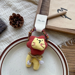 Detail of cartoon lion hair tie with colorful knitted elastic band and fabric texture