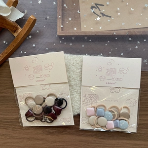 Sweet geometric fabric hair ties for children in soft pastel tones and cute button designs