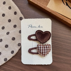 Detail view of retro brown heart fabric hair clips with exquisite stitching for girls
