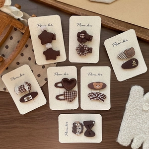 Vintage brown fabric hair clips set for girls featuring star, bear, and floral patterns