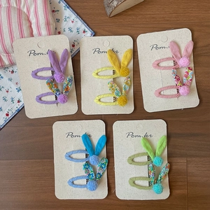 Five pairs of floral rabbit ear hair clips in sweet pastel colors on display card