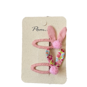 Floral bunny ear hair clips set for girls featuring pink pompom and fabric wrapping