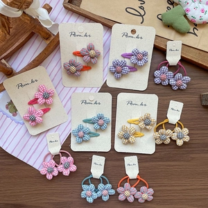 Sweet plaid flower hair clips and elastic ties set in various macaron colors on wood