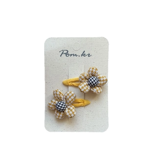 Pair of sweet yellow houndstooth flower hair clips for girls on white background
