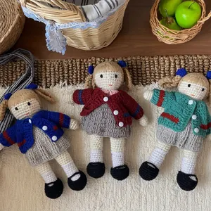Handmade knitted wool doll collection in colorful cardigans for nursery decor