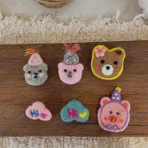 Cute handmade wool felt cartoon animal brooches with bear and cat shapes in soft pastel colors