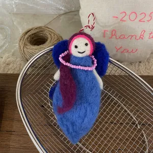 Detail of handmade wool felt doll charm with blue-purple tones and pink bead chain