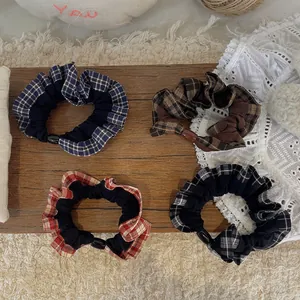 Set of four plaid and solid patchwork scrunchies with decorative buttons in Korean style