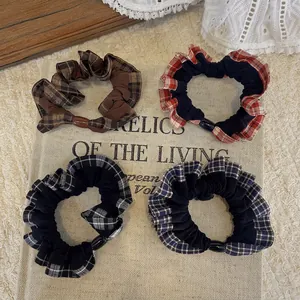 Set of four checkered elastic scrunchies with decorative oval buckles in assorted colors