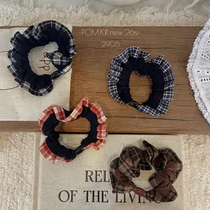 Set of four plaid checkered scrunchies with lace trim in black, blue, red, and brown