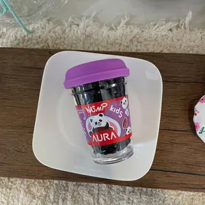Cup-packed black high-elastic hair ties for kids with cute panda label on a white tray