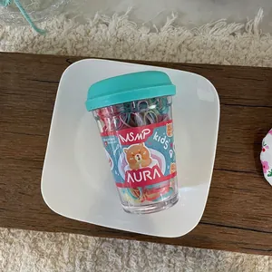 Detail view of colorful high-elasticity hair ties in a transparent coffee cup packaging