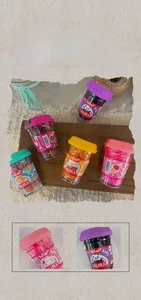 Detailed view of colorful elastic hair bands for children in a clear plastic cup package