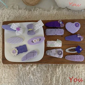 Handmade purple fabric bow hair clips set with embroidery and lace details