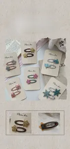 Detailed view of sparkly fabric star hair clips for kids showing fabric texture and size