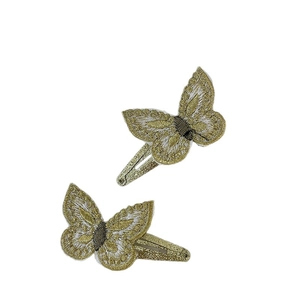 Pair of elegant gold and white embroidered butterfly hair clips with golden glitter bases