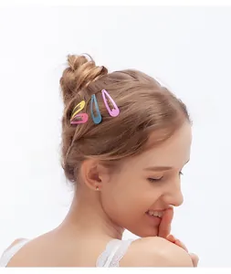 Close-up of four colorful candy-colored drip oil hair clips worn on a child hairstyle