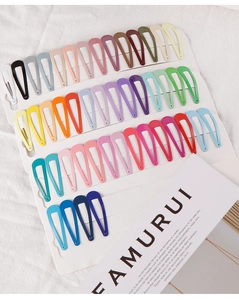 Close-up of colorful candy-colored metal snap clips neatly arranged on a white display card