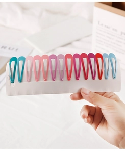 Detailed set of 15 colorful matte teardrop hair clips displayed on a white card
