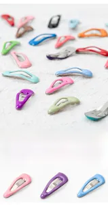 Macro detail of multi-colored 2cm mini pet hair clips in assorted glossy metal finishes