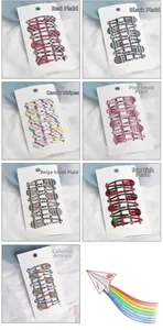 Detail of colorful plaid and striped BB hair clips set on a white card display