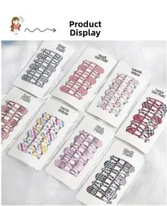 Detail view of 8-pack kids plaid and striped metal BB hair clips on white tulle backdrop