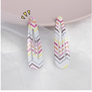 Detail view of colorful wave pattern BB hair clips for girls in a sweet minimalist style