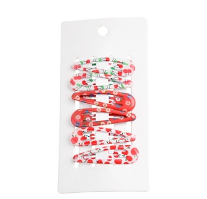 Detail view of red fruit and floral print snap hair clips on white display card