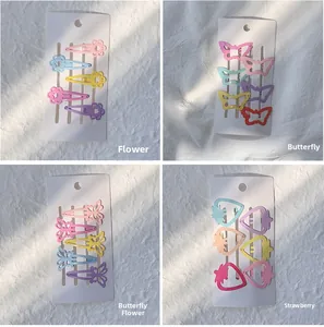 Détail de barrettes BB macaron pour enfants avec motifs fleurs, papillons et fruits