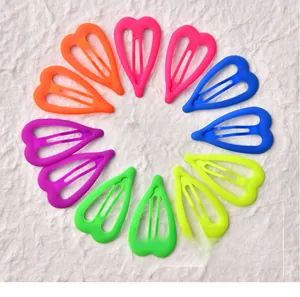 Flat lay of colorful heart-shaped neon hair clips in six vibrant fluorescent shades