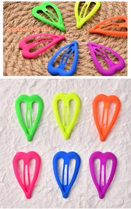 Detailed view of neon matte heart snap hair clips in six vibrant fluorescent colors