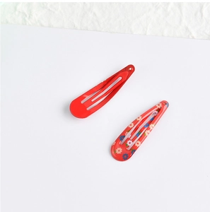 Detail of red and floral 5cm metal hair clips set for girls with glossy finish