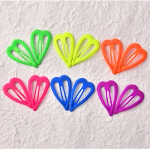 Flat lay of colorful heart-shaped matte hair clips in vibrant neon colors