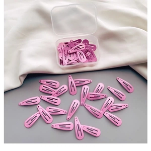 Matte Haarspangen in Rosa und Lila für Mädchen in einer transparenten Plastikbox