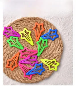 Star-shaped matte hair clips in neon colors displayed on a woven mat for girls