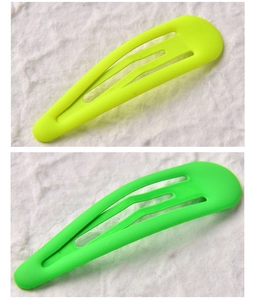 Detail view of matte fluorescent yellow and green water drop shape snap hair clips
