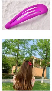Detail showing colorful matte neon snap hair clips in purple, pink and orange colors